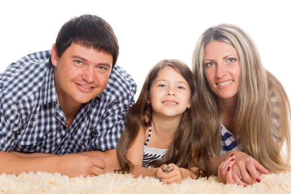 Šťastná rodina, leží na koberci — Stock fotografie