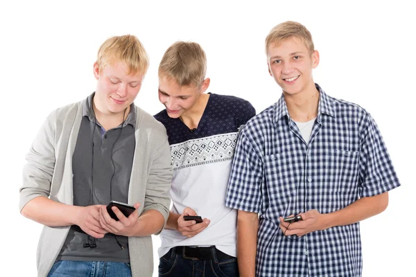 Tres chicos jóvenes usan teléfonos inteligentes —  Fotos de Stock