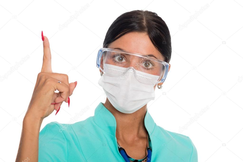 Doctor in a mask with a raised finger