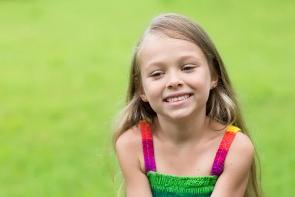 Girl sitting on the lawn — Stock Photo, Image