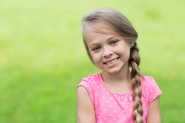 Smiling blond girl with braids — Stock Photo, Image