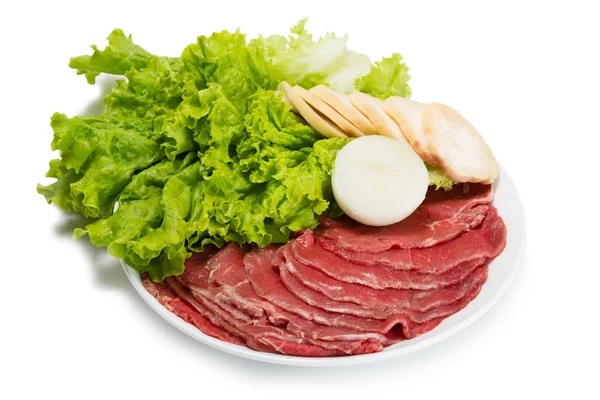 Raw fresh thinly sliced meat with lettuce — Stock Photo, Image