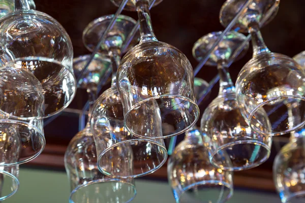 Wine glasses hanging above the bar rack — Stock Photo, Image