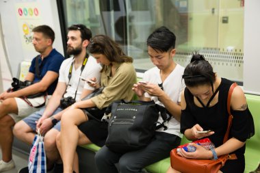 People traveling on the subway in Singapore clipart
