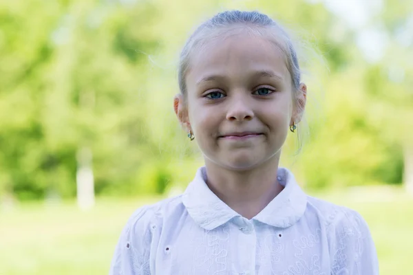 Portrait of a blond girl in park — Stock Photo, Image