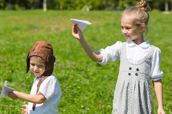 Małe dzieci bawiące się w papierowe samoloty — Zdjęcie stockowe