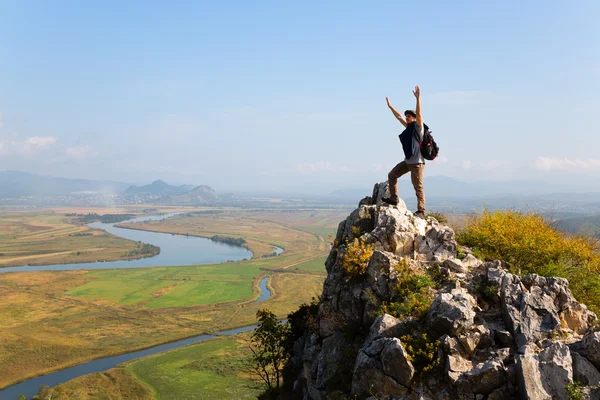 Hiker raises his arms up and screaming with delight — Stock fotografie