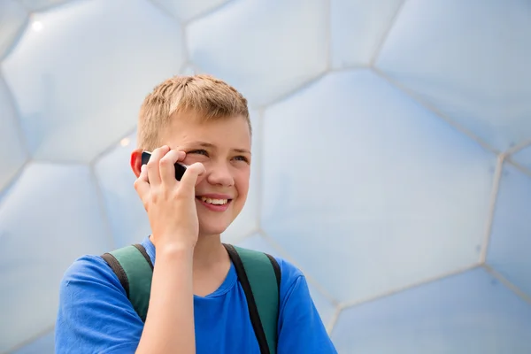 Boy talking on cell phone in the Olympic Park, Beijing — Zdjęcie stockowe