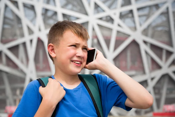 Boy talking on cell phone in the Olympic Park in Beijing — Stok fotoğraf