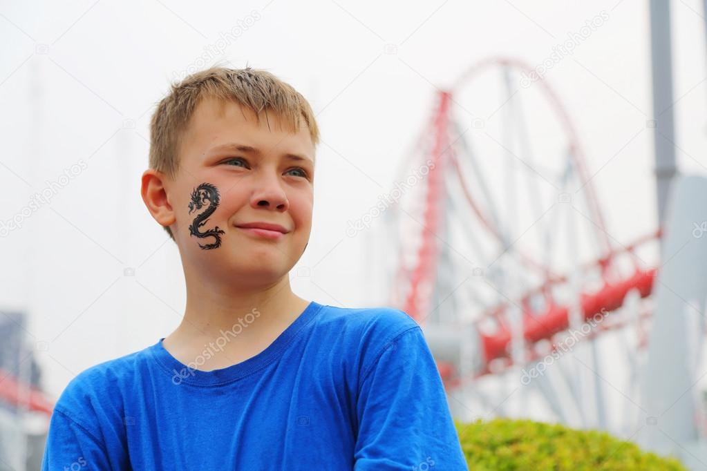 Portrait of a boy at an amusement park