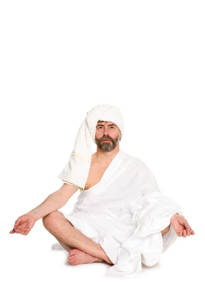 Man sitting in the lotus position, dressed clothes of bath — Stock Photo, Image