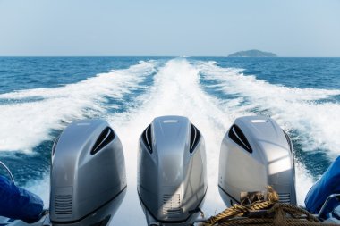 Three powerful engines mounted on the speedboat clipart