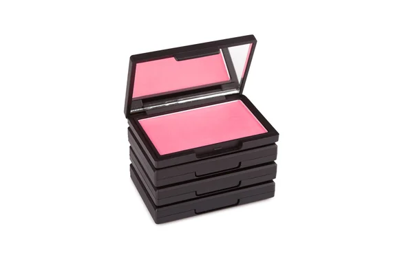 Pink blush on a pile of blush boxes isolated on white — Stock Photo, Image