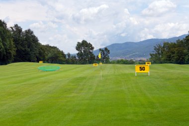 Practicing range at a golf course, with table marking 50 meters