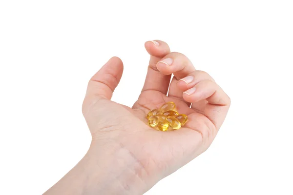 Cod liver oil pills in hand on white — Stock Photo, Image