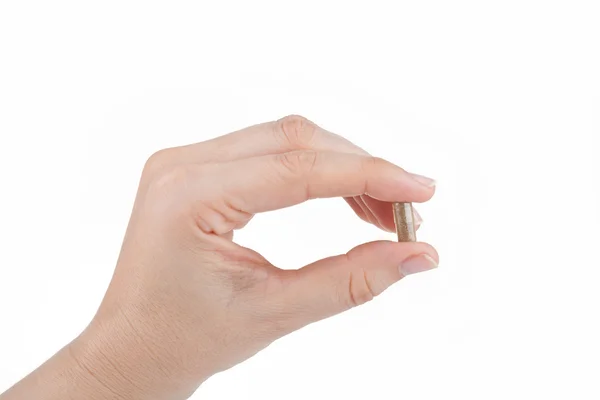 Woman's hand holding a herbal pill — Stock Photo, Image