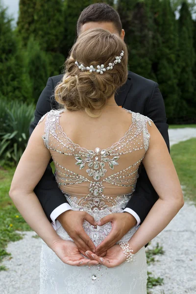 Groom making a heart sign with his hands — Stock Photo, Image