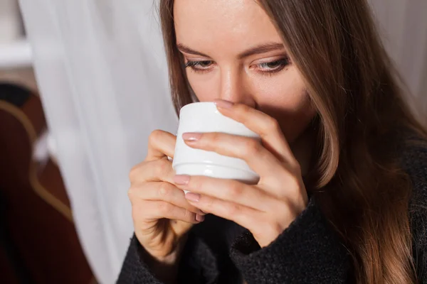 Woman near window drinking coffee — Stock Photo, Image