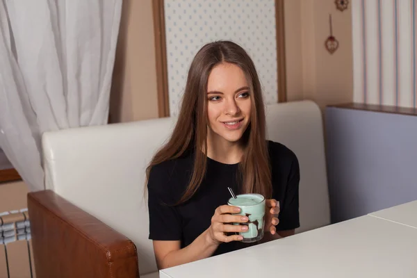 Junge Frau trinkt Kaffee — Stockfoto