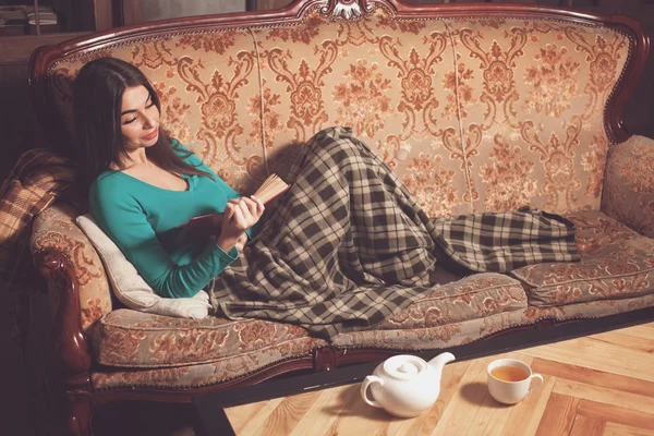 With red book on sofa — Stock Photo, Image