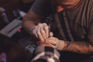 Tattoer using tattoo machine clipart