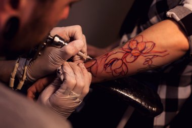 Tattoo artist works in salon clipart