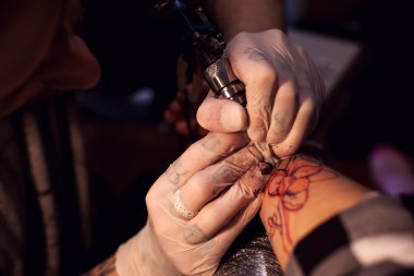 Tattoo artist works in salon clipart