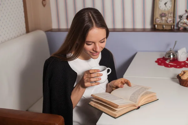 Woman with book and tea