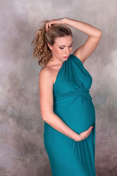 Pregnant woman in blue dress — Stock Photo, Image