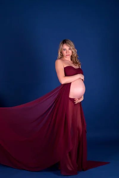 Pregnant woman in red dress — Stock Photo, Image