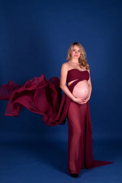 Pregnant woman in red dress — Stock Photo, Image