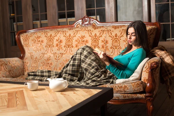 With book on sofa — Stock Photo, Image