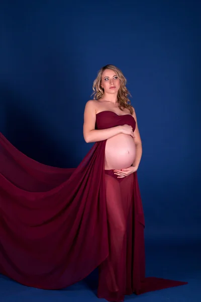 Pregnant woman in red dress — Stock Photo, Image