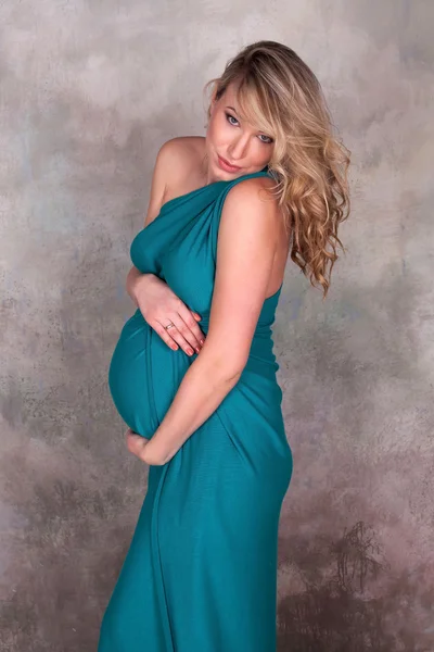 Pregnant woman in blue dress — Stock Photo, Image