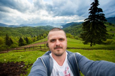 Hill ve çekici fotoğraf üzerinde duran genç adam inanılmaz olmak