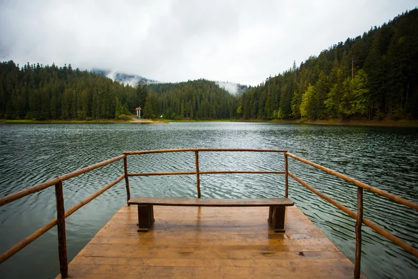 Beautiful lake with wooden bridge — Stock Photo, Image