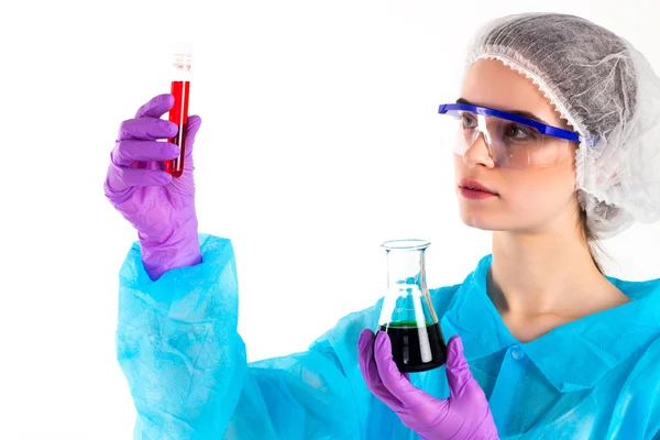 Woman holds a tube and a flaks — Stock Photo, Image