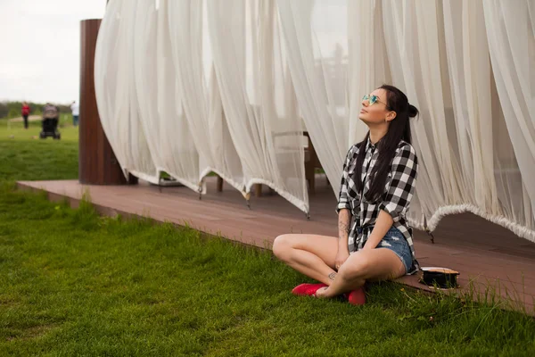 La femme est assise sur un plancher de bois — Photo