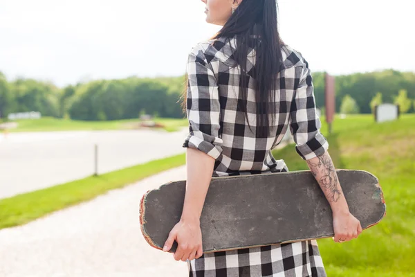 De vrouw houdt een skate — Stockfoto