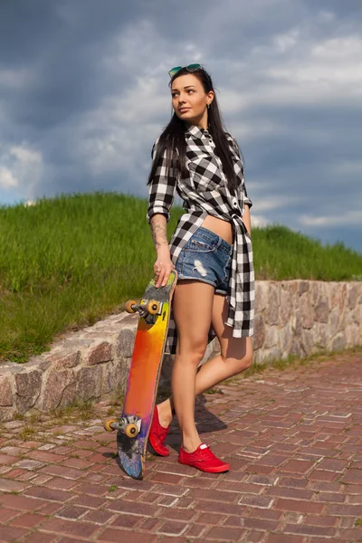 Η γυναίκα στέκεται με ένα skate — Φωτογραφία Αρχείου