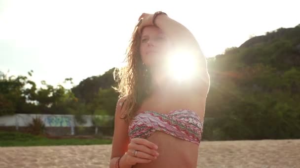 Woman smiling and looking in camera at sunset — Stock Video