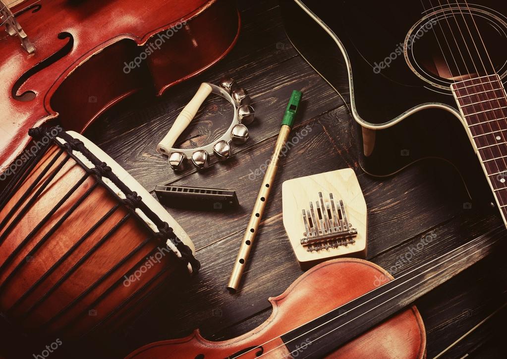 kranium Grund George Bernard Set of musical instruments on dark wooden background Stock Photo by  ©silverjohn 119587400