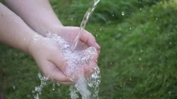 Water stream into womans hands — Stock Video