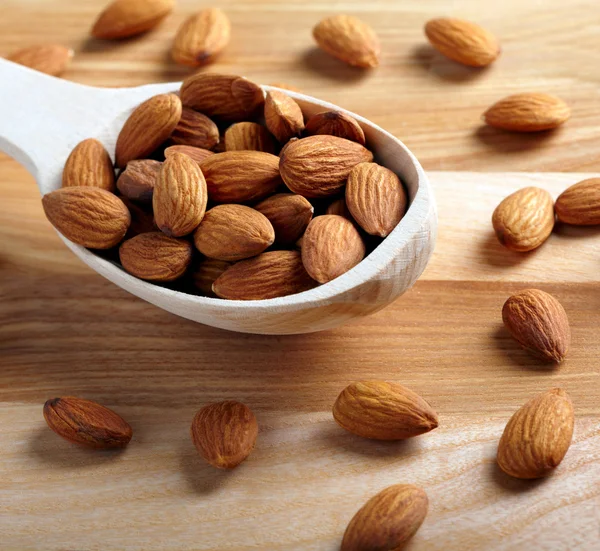 Almonds on wooden background — Stock Photo, Image