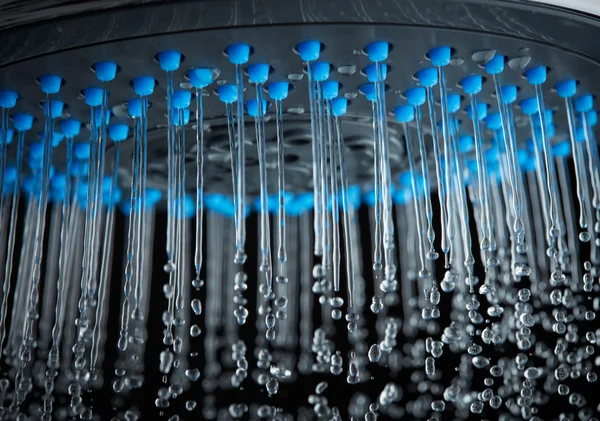 Shower with running water over dark background — Stock Photo, Image