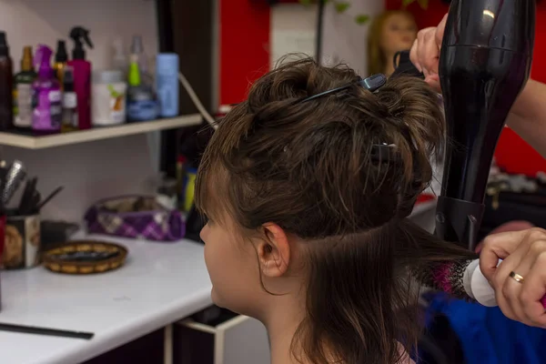 Beautiful teen girl at the hairdresser blow drying her short hair — Stock Photo, Image