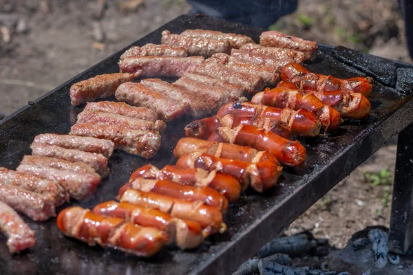 Grilling meat on bbq stone grill in nature — Foto Stock