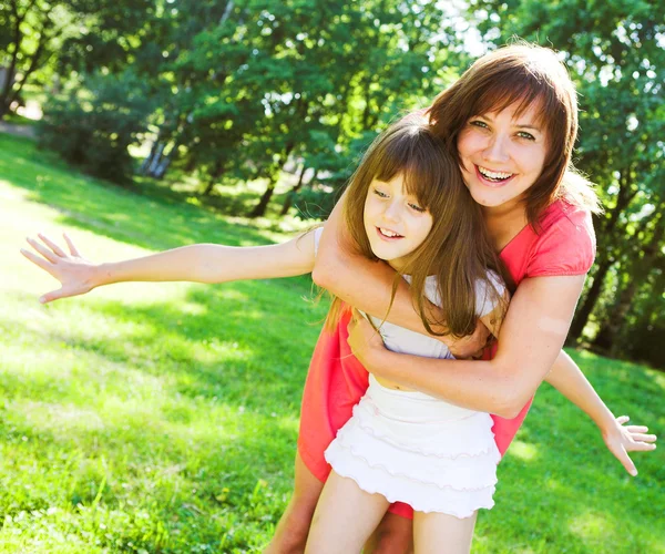 Mother and daughter smiling outdoor. — Stock Photo, Image
