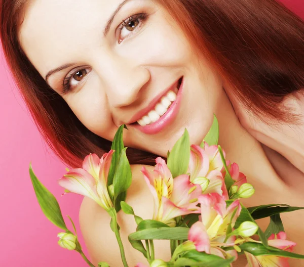 Young beautiful woman with pink flower — Stock Photo, Image