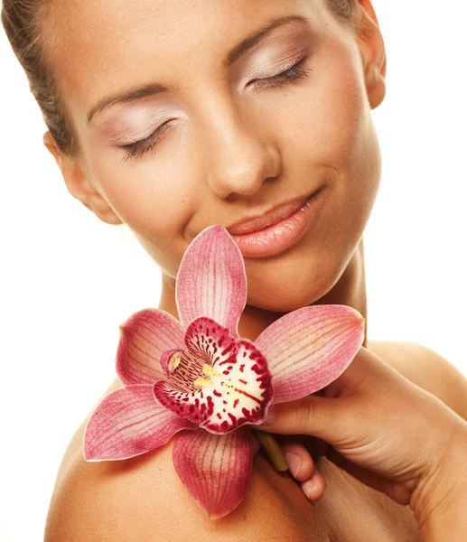 Jonge mooie vrouw met roze orchidee, geïsoleerd op witte achtergrond Stockafbeelding